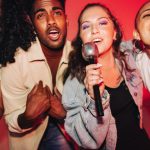 Vibrant friends singing together on karaoke night